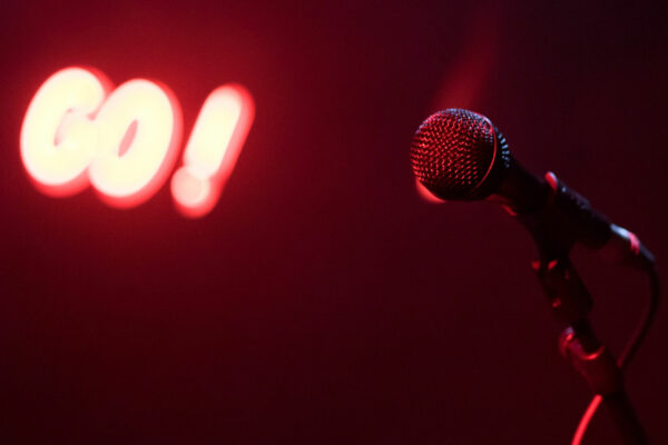 microphone with neon go sign