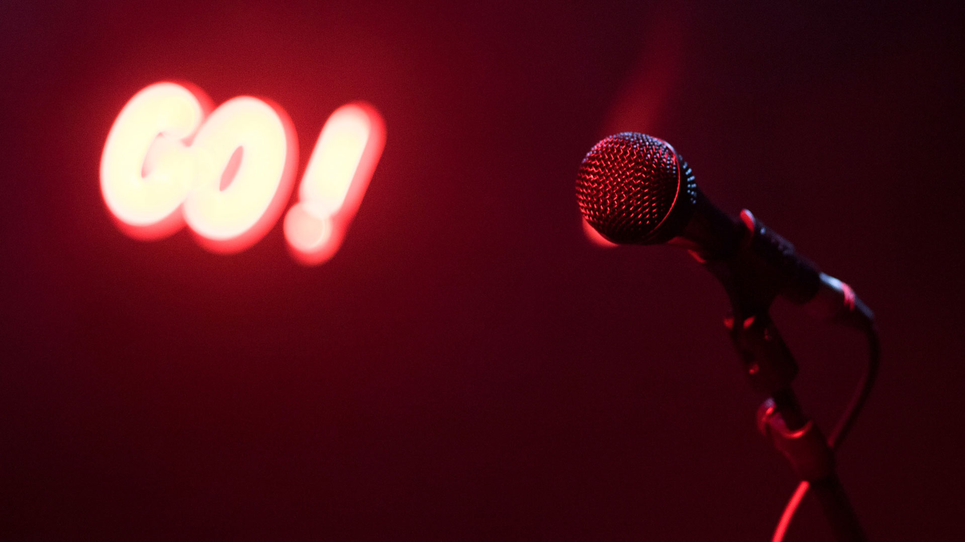 microphone with neon go sign